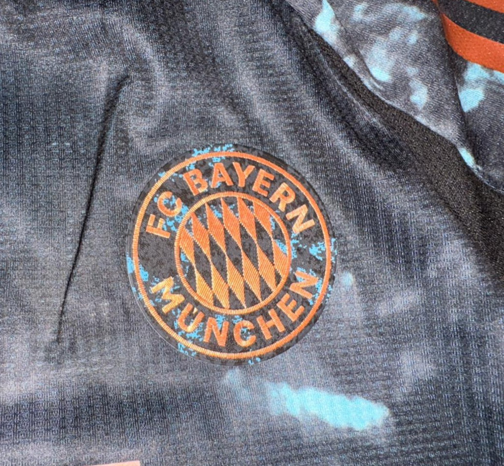 FC Bayern Munich logo on a dark fabric background